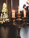 Vintage retro brass candlesticks with candles burning, luxury event banquet table setting decoration in a restaurant hall, Royalty Free Stock Photo