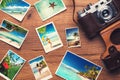 Vintage retro camera with travel photos on wooden background Royalty Free Stock Photo