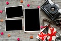 Vintage retro camera on wood table background with blanks photos Royalty Free Stock Photo