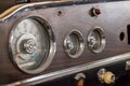 Vintage retro car dashboard with analog speedometer, tachometer and odometer, handmade with wood and chrome for