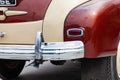 Vintage retro car rear chrome bumper with taillamp in beige and brown color, handmade with wood and chrome for restoration. Auto Royalty Free Stock Photo
