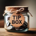 Vintage retro glass jar with hemp rope tie tip box tag and few coins inside on wood counter Royalty Free Stock Photo