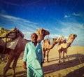 Cameleer camel driver with camels in dunes of Thar desert. Raj Royalty Free Stock Photo