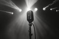 vintage retro microphone on stage under spotlights, black and white Royalty Free Stock Photo