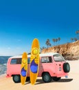 Pink Vintage, Retro, Old-fashioned mini bus van camper VW T2 with surfboard on beach, cliff, palm tree Royalty Free Stock Photo