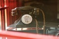 Vintage retro phone in a traditional british red booth close up Royalty Free Stock Photo