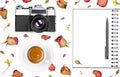 Vintage retro photo camera, notepad, pen, coffee cup and dried flowers isolated on white background. Flat lay. Royalty Free Stock Photo