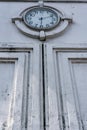 Vintage and retro public city clock showing the time on the white wall ornament with low angle view Royalty Free Stock Photo