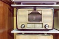 Vintage retro radio on wooden shelf. Retro technology