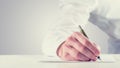 Vintage retro style image of a man signing a paper