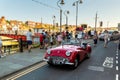 Vintage retro Triumph compact red sports car at Typical tourist street in Whitby, UK