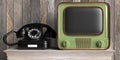 Vintage retro TV and telephone on wooden table, wood wall background. 3d illustration Royalty Free Stock Photo