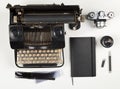 Vintage retro typewriter, analog film camera and notebook with pen on white wooden table background top view flat lay from above Royalty Free Stock Photo