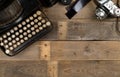 Vintage retro typewriter and analog film camera on wooden table background top view flat lay from above - journalism or writer