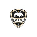 Vintage Rhino Logo. With rhinoceros, shield, and grass icon. Premium, luxury, black, and gold logo design Royalty Free Stock Photo