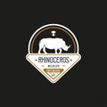 Vintage Rhino Logo. With rhinoceros, shield, and grass icon. Premium, luxury, black, and gold logo design Royalty Free Stock Photo