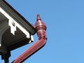 Vintage rain-pipe against blue sky