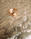 Vintage ring of red gold lies on a silvery volumetric background.