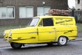 Vintage robin reliant yellow three wheeled car on council estate replica of only fools an