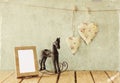 vintage rocking horse next to fabric hearts hanging on the rope Royalty Free Stock Photo