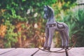 Vintage rocking horse over wooden table outdoors