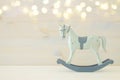 vintage rocking horse on wooden floor. Glitter overlay Royalty Free Stock Photo