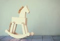 Vintage rocking horse on wooden floor. retro filtered image Royalty Free Stock Photo