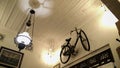 Vintage room with antique chandelier interior with white lamps and old bicycles