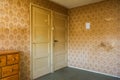 Vintage room with pattern wallpaper and old fashioned closet and door. Rustic interior design. Royalty Free Stock Photo