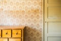 Vintage room with pattern wallpaper and old fashioned closet and door. Rustic interior design. Royalty Free Stock Photo