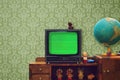 Vintage room with wallpaper, old fashioned shelf, retro tv, globe, rubber toys Royalty Free Stock Photo