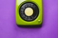 Vintage rotary phone. classic green telephone with round dial. isolated on purple background. old communication technology Royalty Free Stock Photo