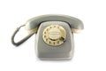 Vintage rotary phone, gray yellowed plastic on a white backgrou Royalty Free Stock Photo