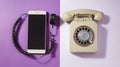 Vintage rotary phone and modern smartphone comparison Royalty Free Stock Photo
