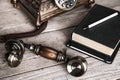 Vintage rotary telephone and old phone book on table near wall Royalty Free Stock Photo