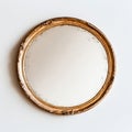 Vintage round mirror with ornate gold frame on white wall Royalty Free Stock Photo