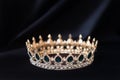 Vintage royal crown, jewellery with emeralds on black background