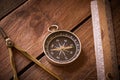 Vintage rule, drawing and navigational Compass on a rustic wooden board Royalty Free Stock Photo