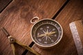 Vintage rule, drawing and navigational Compass on a rustic wooden board Royalty Free Stock Photo