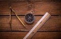 Vintage rule, drawing and navigational Compass on a rustic wooden board Royalty Free Stock Photo