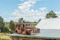 Vintage rusted car on the roof of Cabin Road Stall