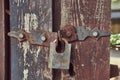 Close-up image of a vintage rusted lock on an old worn wooden fence. Royalty Free Stock Photo