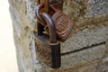 Vintage rusted padlocks on a stone wall in Phong Nha, Vietnam
