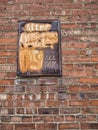 Vintage rusted parking sign on a brick building