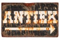 Vintage rusted sign with the Dutch word `Antique` isolated on wh Royalty Free Stock Photo