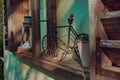 Vintage rustic bicycle and lamp on a wooden surface