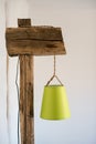 Vintage rustic lamp made of old wooden beams and stump base against white interior in  a village house Royalty Free Stock Photo