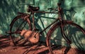 Vintage rustic metallic bicycle with blue wall as a background with light and shadow can be used as a advertising