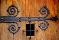Vintage rustic old oak door detail with mounted wrought iron hinge Royalty Free Stock Photo