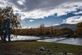 Vintage rustic suspension bridge over river in autumn. River crossing concept. Royalty Free Stock Photo